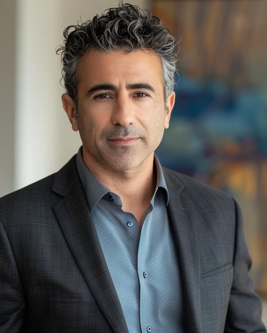 How much is Tony Khan worth in 2024? Tony Khan standing beside 2024 net worth chart, highlighting substantial increase in wealth.