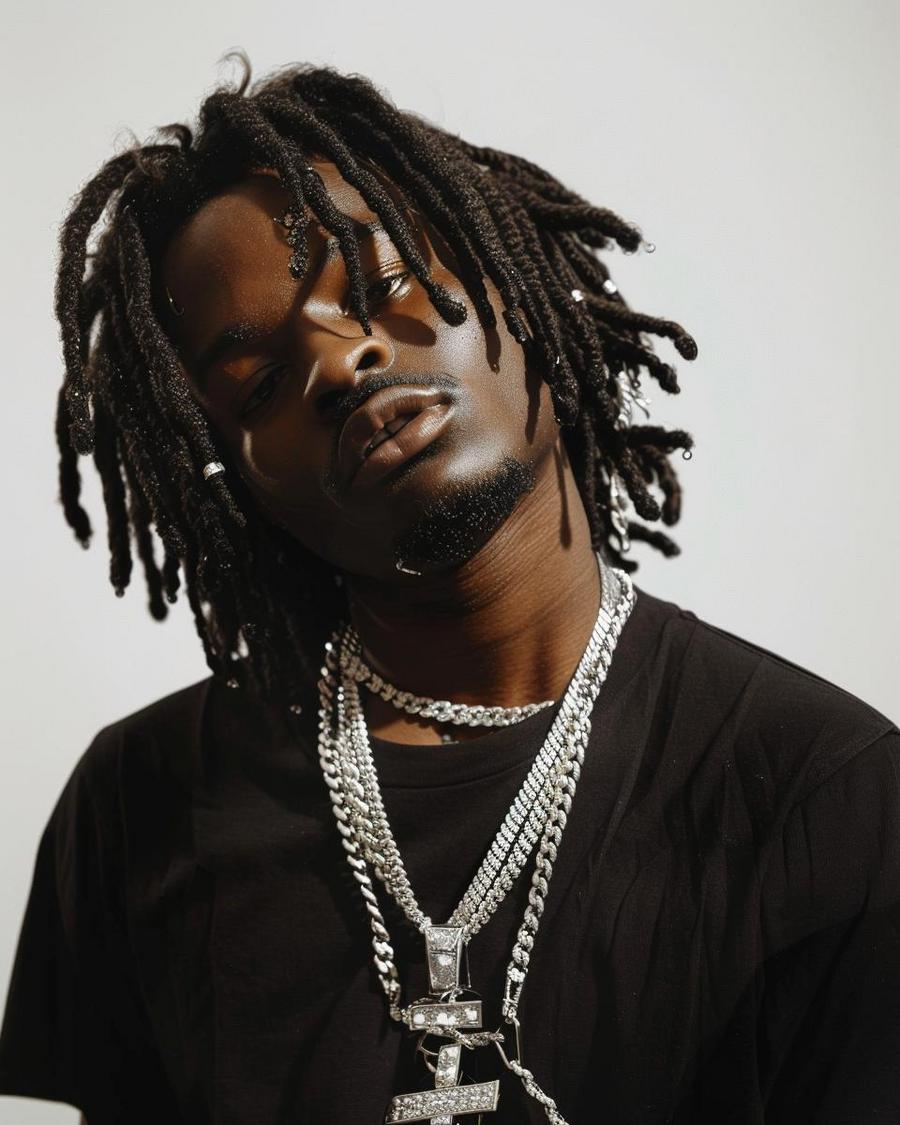 How Has Young Nudy Built His Net Worth? Young Nudy posing, infographic on how he built his net worth in the background.